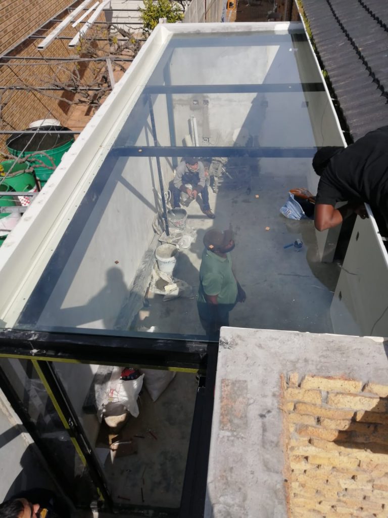Glass pergola roof installed over a patio