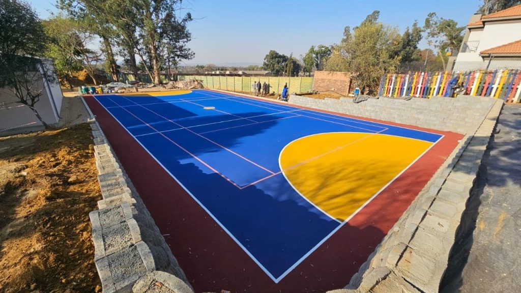 New blue acrylic tennis court built by Kiki Projects